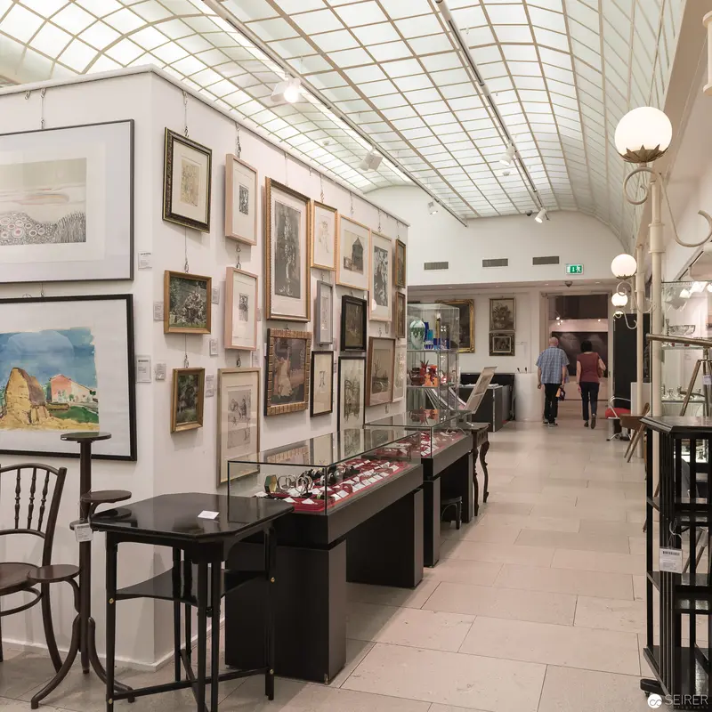 Interior View of Museum Gallery with Artwork and Display Cases