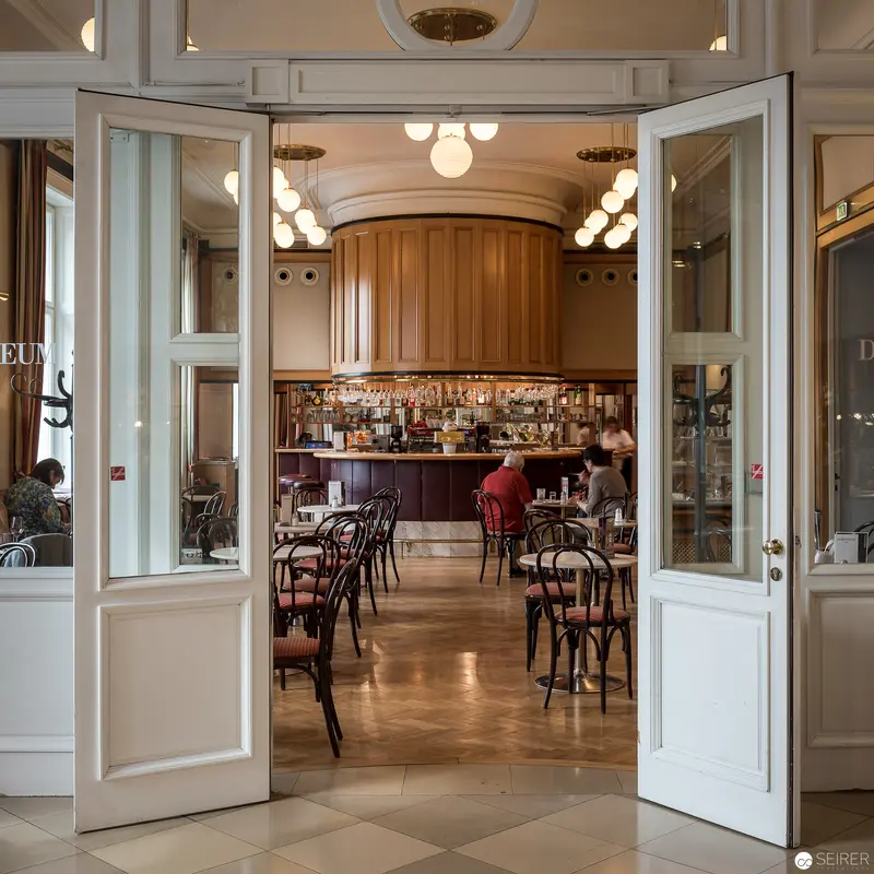 Elegant Interior View of Classic Cafe Through White Double Doors