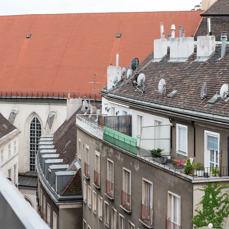 Urban Roofscape: Satellite Dishes and Architectural Layering in Central European City