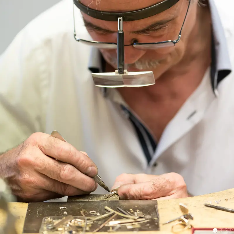 Jeweler at Precision Workbench Using Specialized Magnification Eyewear