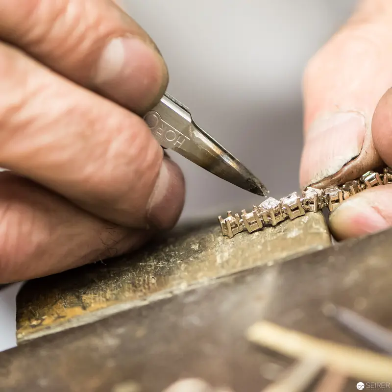 Precision Metalwork: Jeweler's Delicate Hand Engraving Intricate Metal Surface