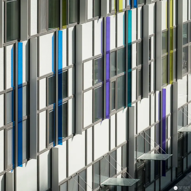 Geometric Facade of Wien Nord Hospital with Colored Glass Panels