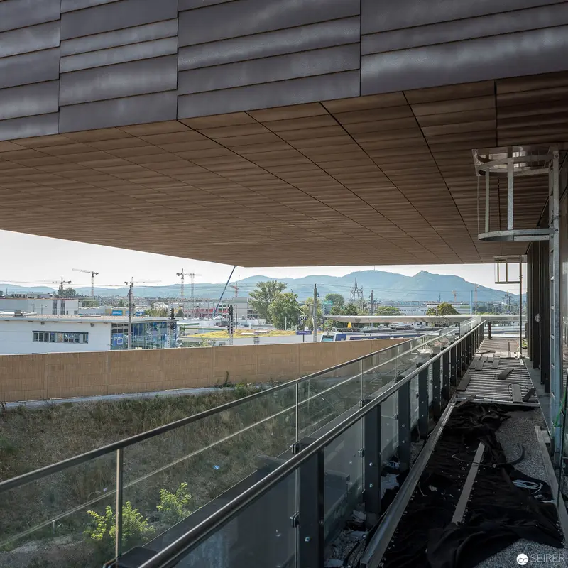 Modern Hospital Walkway at Wien Nord with Mountain Landscape Backdrop