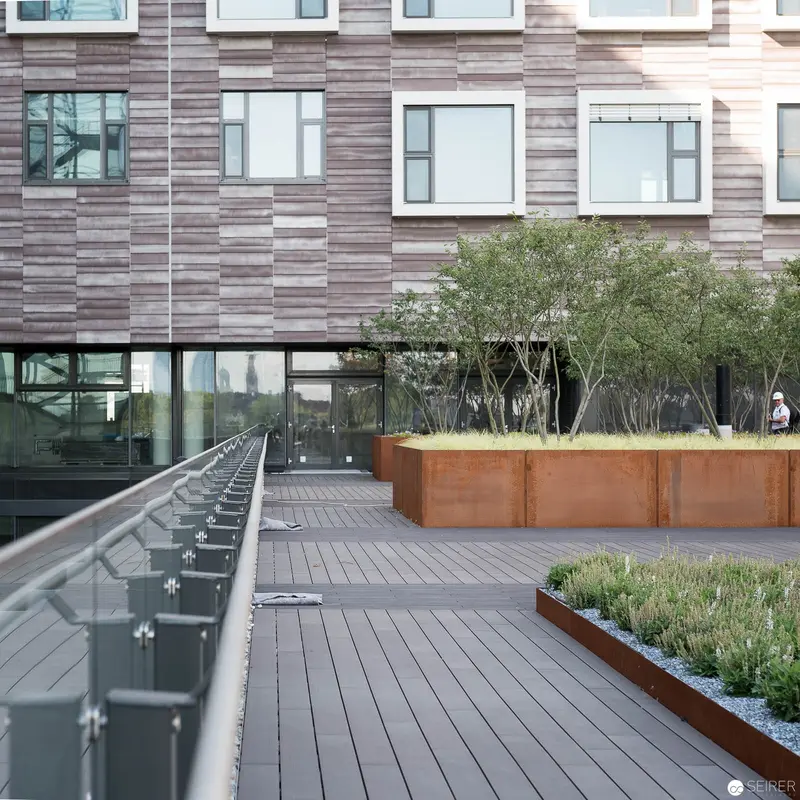 Contemporary Urban Terrace with Corten Steel Planters and Minimalist Architectural Design