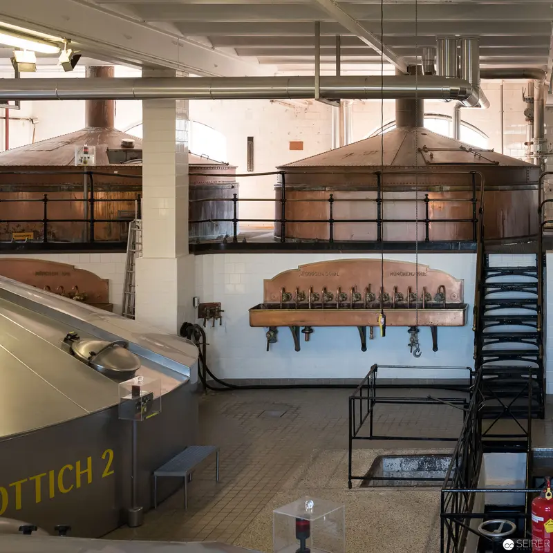Industrial Brewing Facility Interior with Copper Fermentation Tanks and Processing Equipment