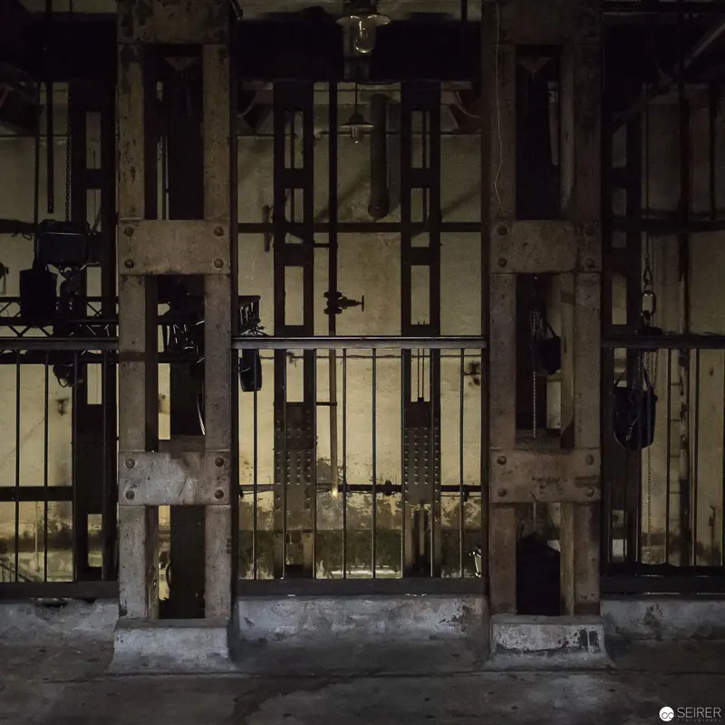 Industrial Elevator Shaft with Concrete Supports and Metal Gating