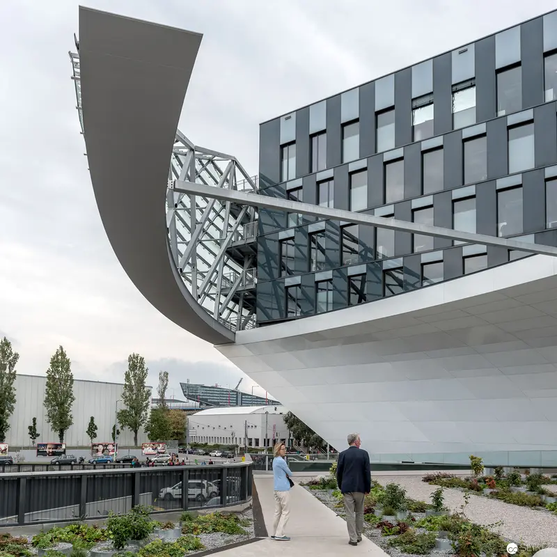 Modern Architectural Intersection with Curved Glass and Geometric Office Building