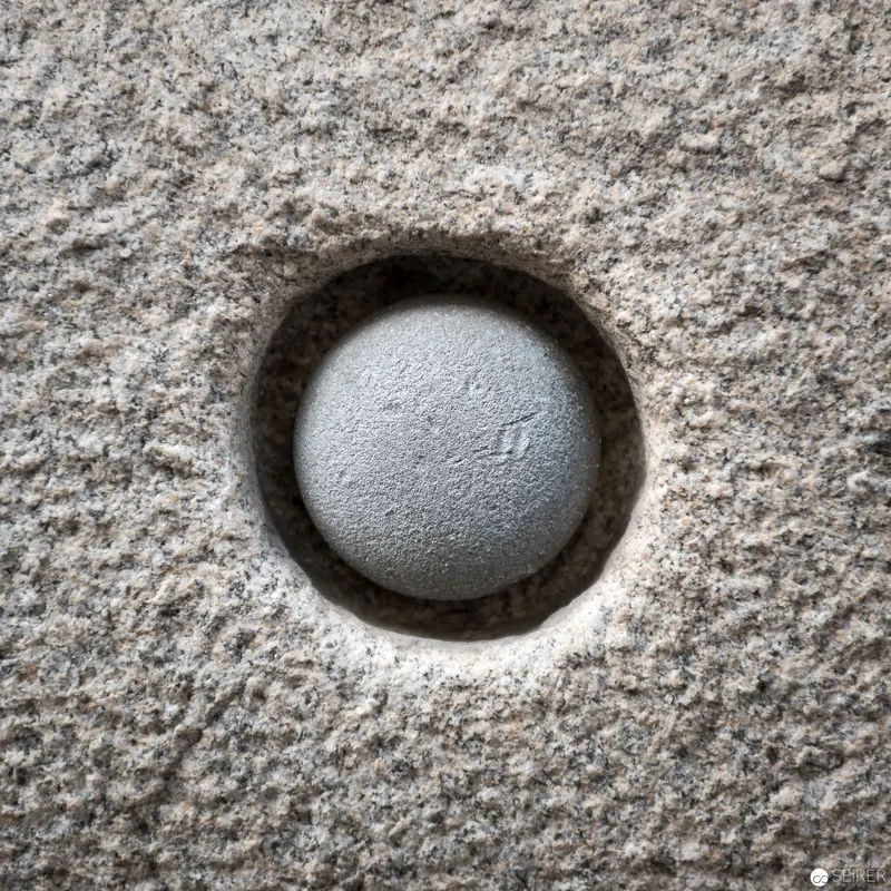 Concentric Geometric Study: Stone Sphere Embedded in Textured Surface