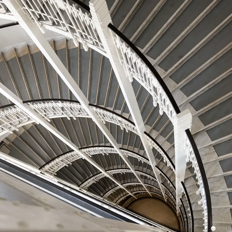 Intricate Architectural Spiral Staircase with Geometric White Structural Elements
