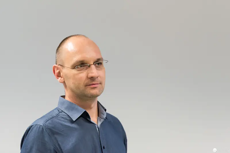Microsoft User Group Meeting: Portrait of a Professional in Blue Shirt