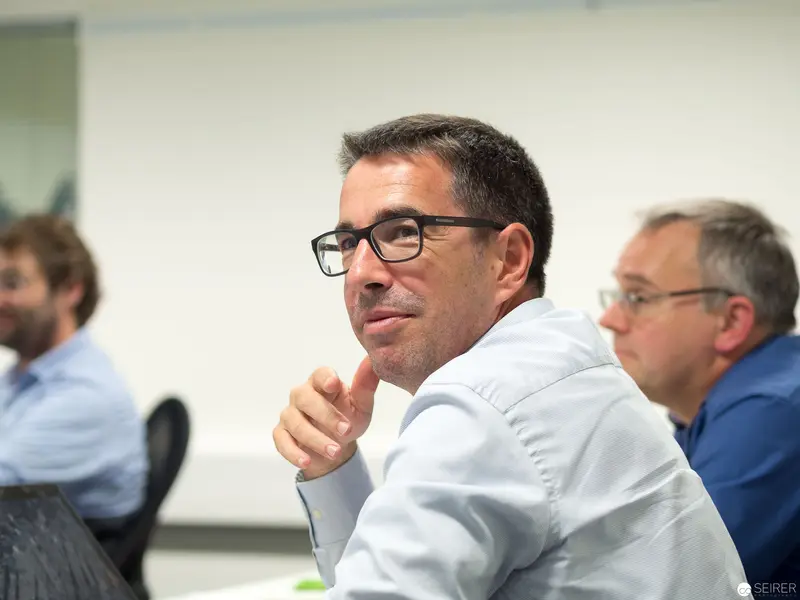 Microsoft User Group Meeting: Attentive Participant in White Shirt and Glasses
