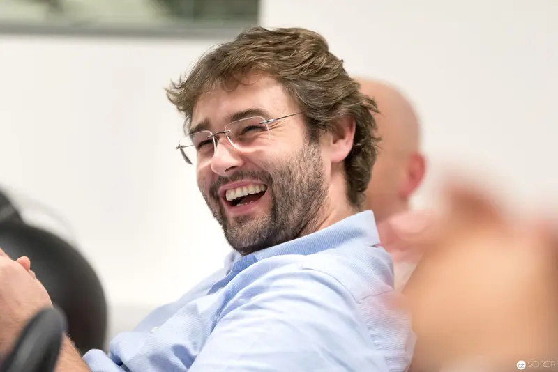 Microsoft User Group Meeting: Bearded Participant Laughing During Interactive Session