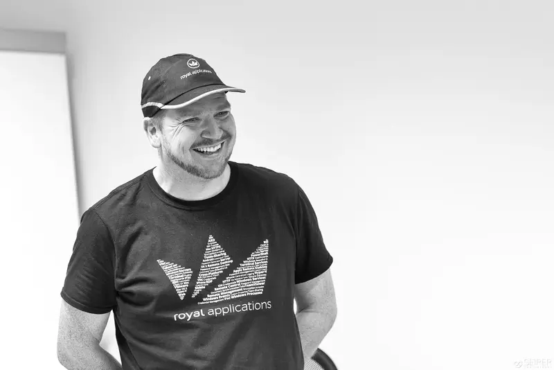 Royal Applications Developer Smiling in Black and White Corporate Portrait