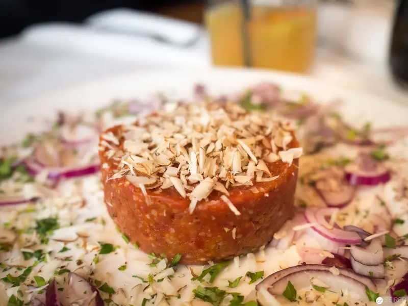 Tartare with Toasted Almonds on Herbed Canvas at Benjaminis Restaurant, Vienna