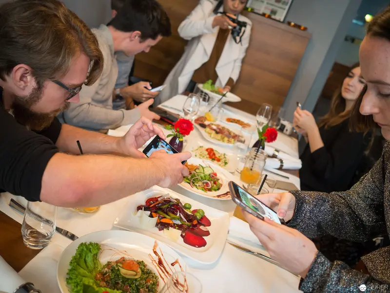 Benjaminis Restaurant Patrons Documenting Culinary Presentation with Smartphones in Vienna