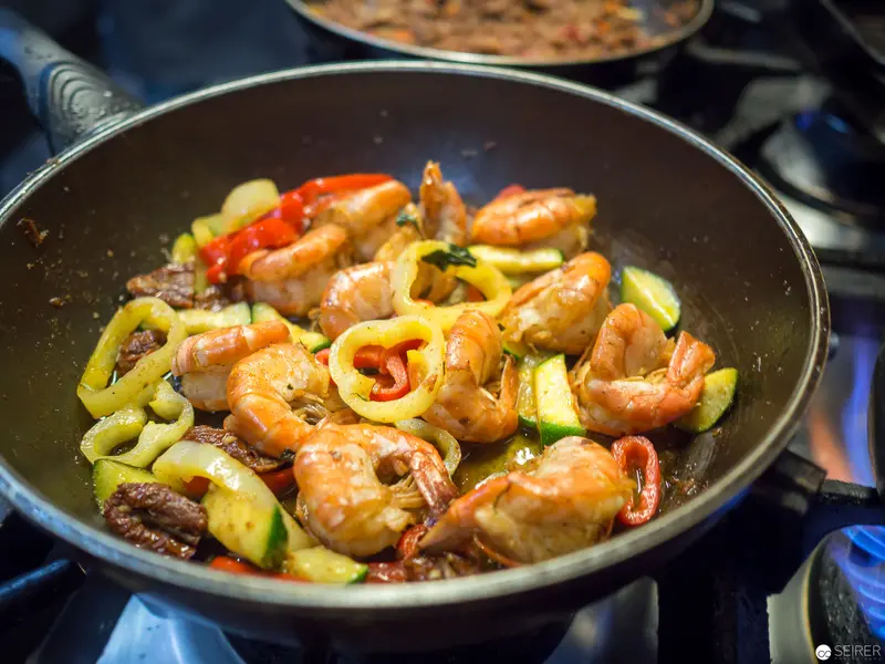 Sizzling Shrimp and Vegetable Stir-Fry in Professional Kitchen Skillet