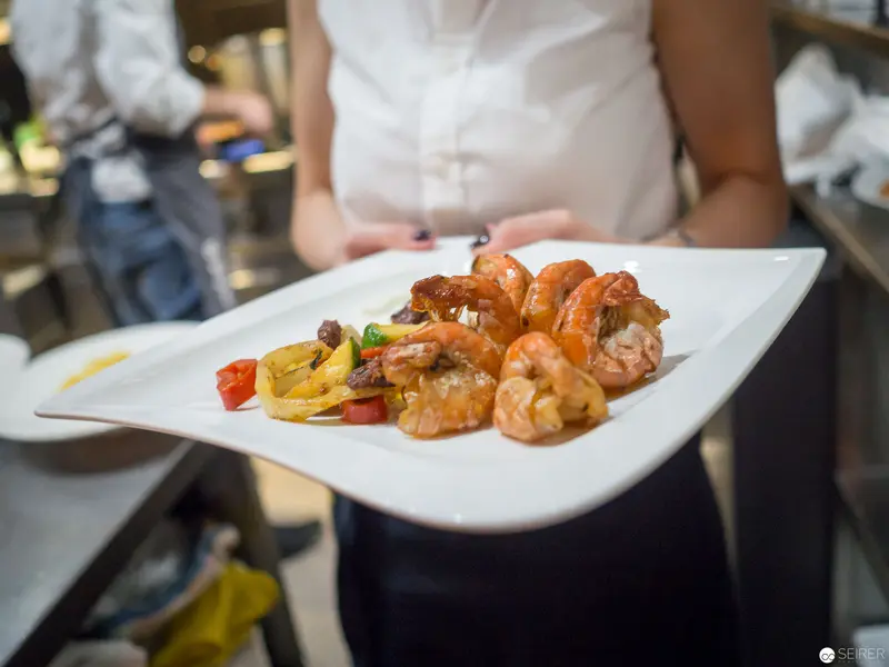 Benjaminis Restaurant: Grilled Shrimp Plated with Vibrant Garnishes