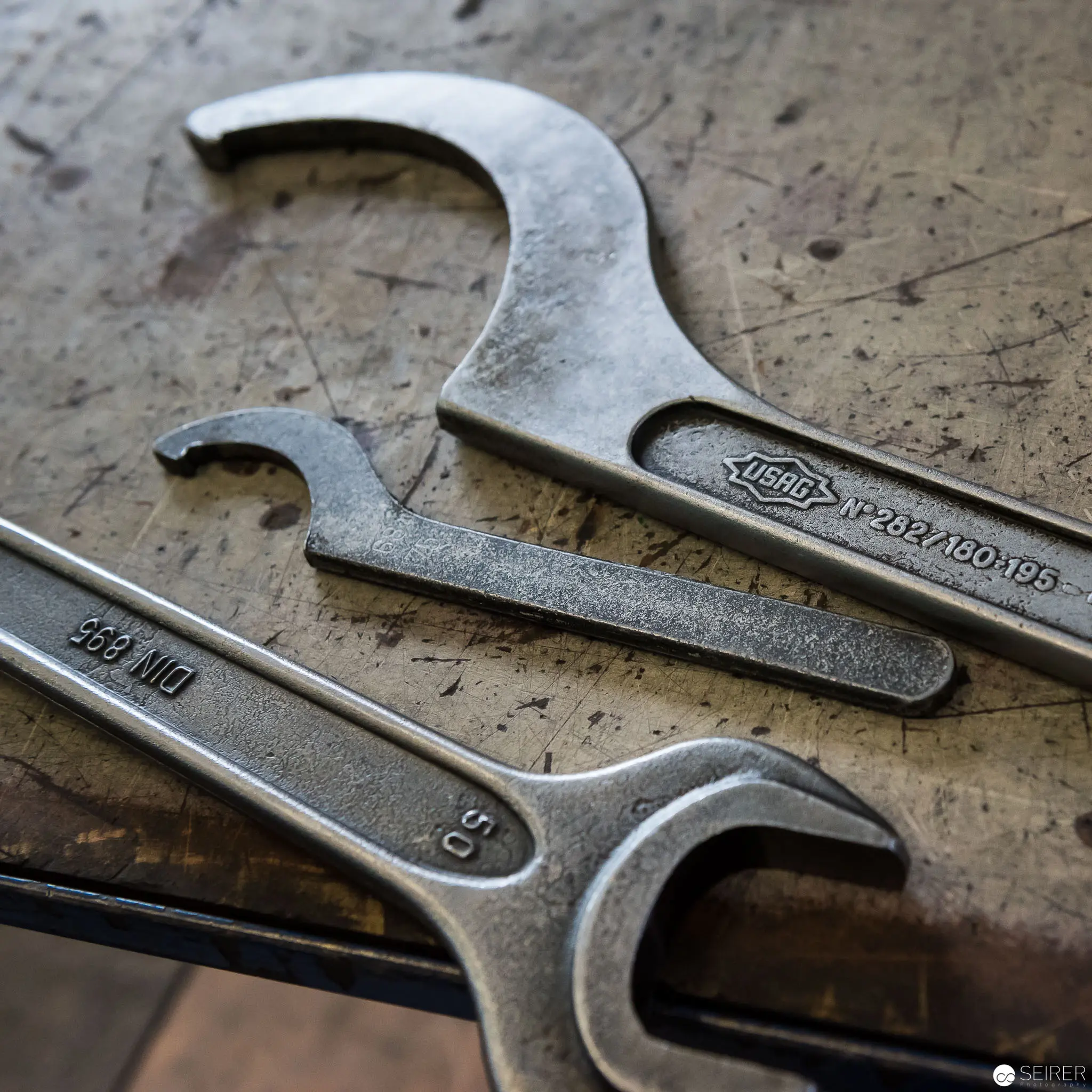 Precision Wrenches on Textured Workshop Surface at Riess Manufactory
