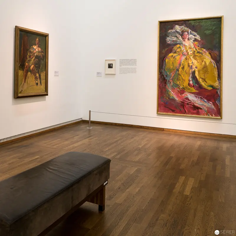 Gallery Interior with Vibrant Portrait Paintings and Minimalist Bench