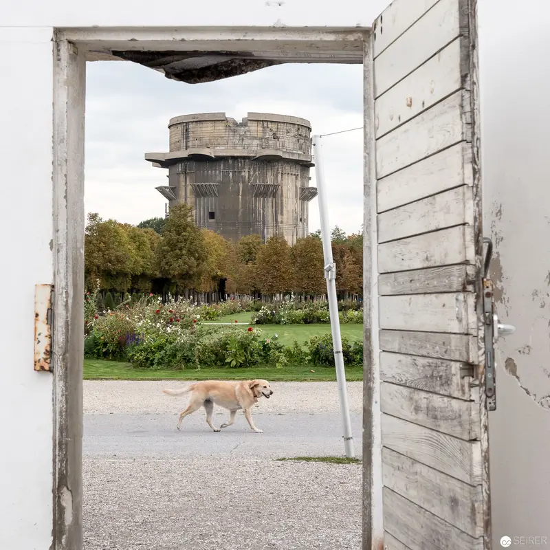 Concrete Defense Tower Framed by Weathered Wooden Door in Augarten Park, Vienna