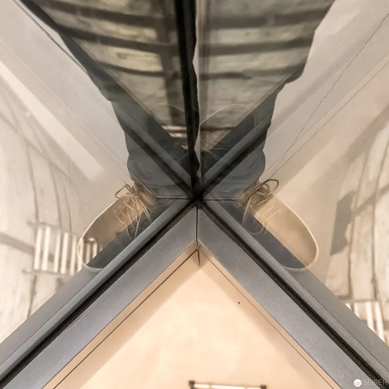 Symmetrical Reflection of Minimalist Interior with Architectural Glass Intersection