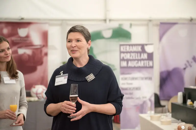 Ceramic Porcelain Event in Austria: Professional Woman at Exhibition Podium