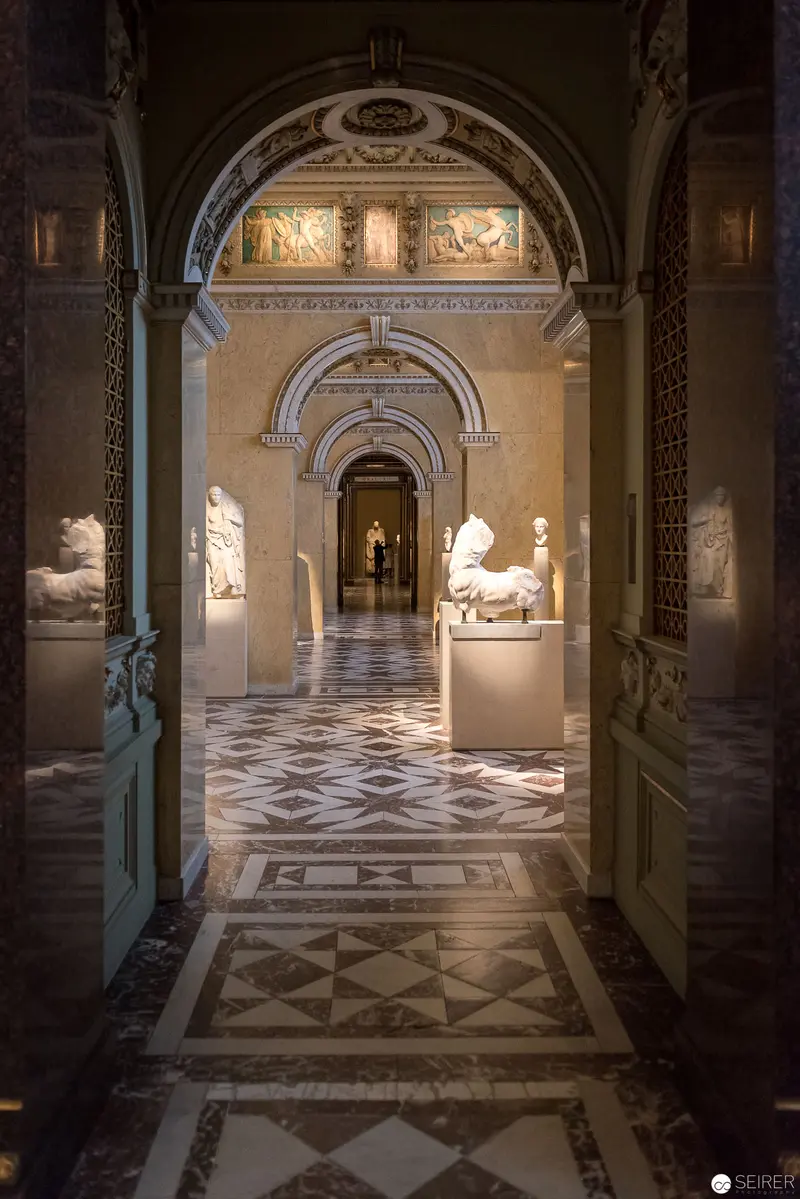 Archival Gallery Interior with Marble Floor and Arched Architectural Passageways
