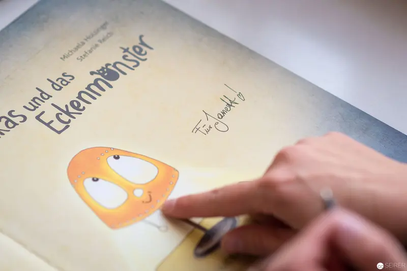 Close-up of Children's Book Page Featuring Cartoon Monster Character