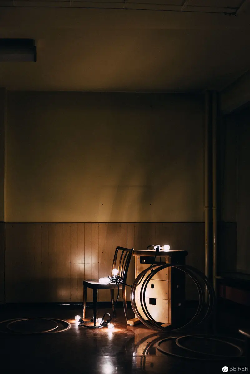 Intimate Performance Staging with Candlelight and Shadows in Empty Interior