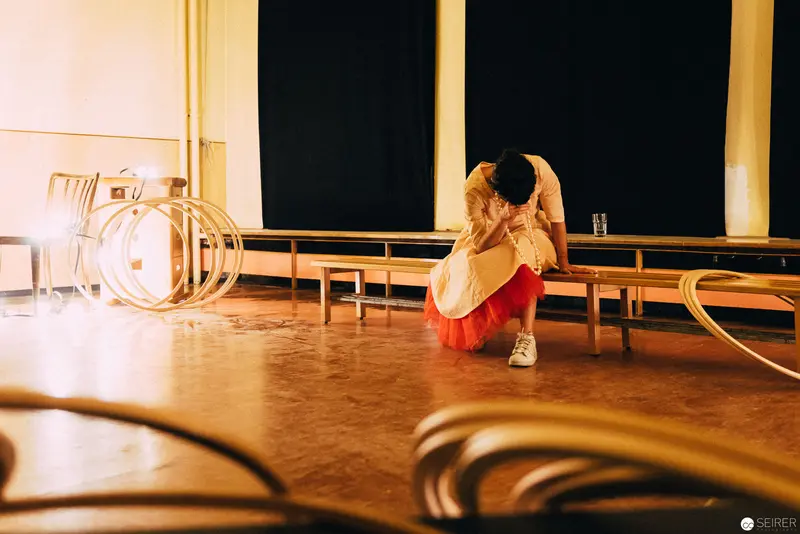 Performer in Red Skirt Contemplating during Nesterval's "Dirty Faust" Performance