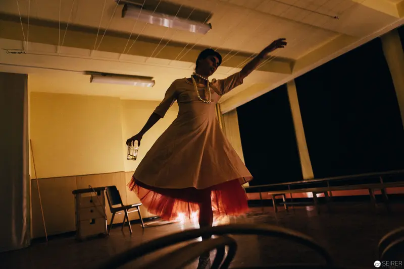 Performer in Luminous Dress Enacts Dramatic Pose during Nesterval's "Dirty Faust"