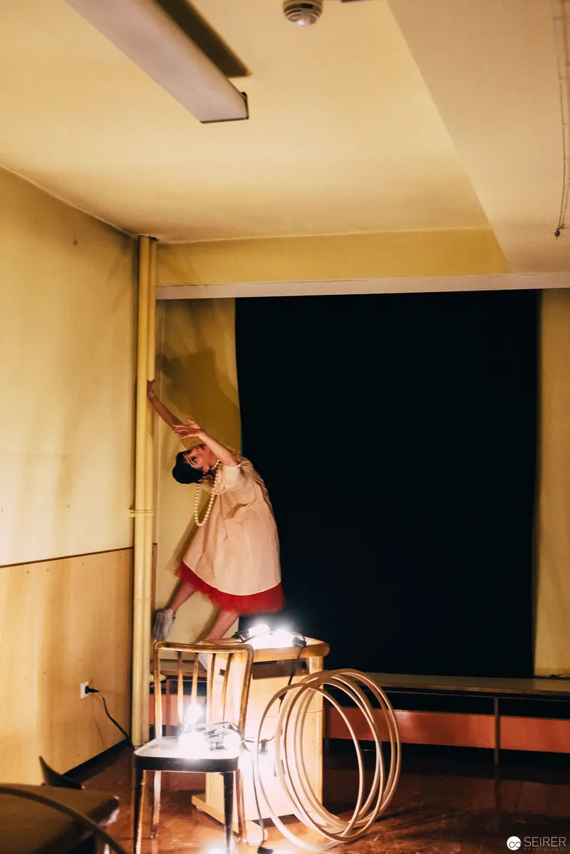 Performer Stretching on Chair During Nesterval's "Dirty Faust" Performance in Vienna