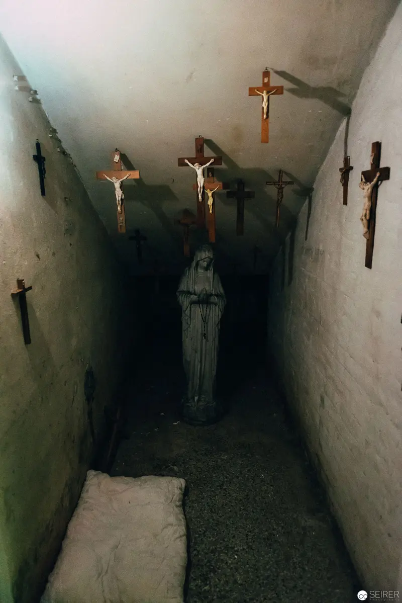 Crucifixion Tableau in Narrow Corridor with Religious Iconography