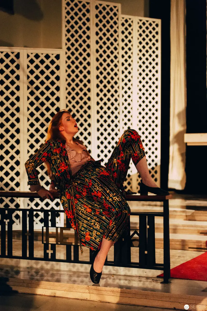Performer in Vibrant Dress During Nesterval's "Dirty Faust" Theatrical Performance