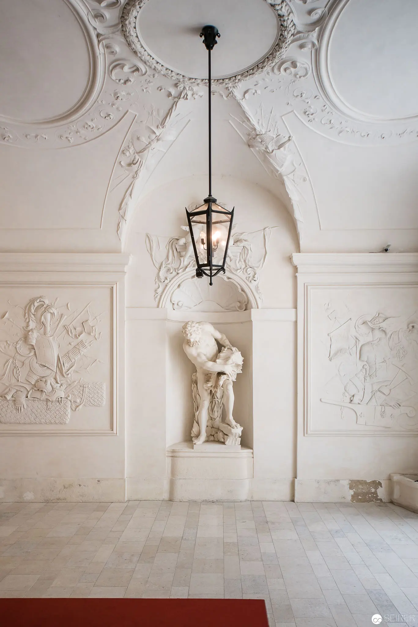 White Baroque Interior with Classical Statue at Prince Eugene's Winter Palace, Vienna