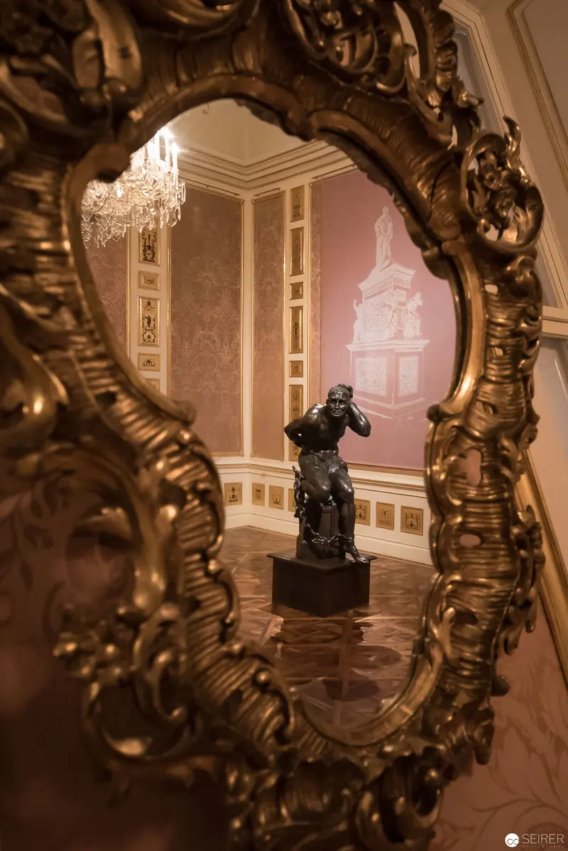 Ornate Baroque Mirror Reflecting Sculptural Tableau in Winter Palace Interior