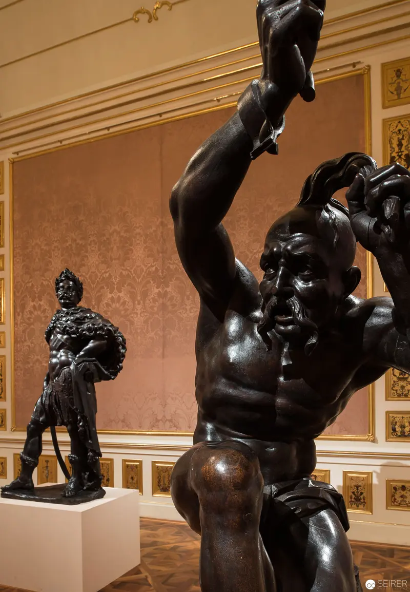 Baroque Bronze Sculptures Displaying Dynamic Muscular Physicality in Ornate Interior