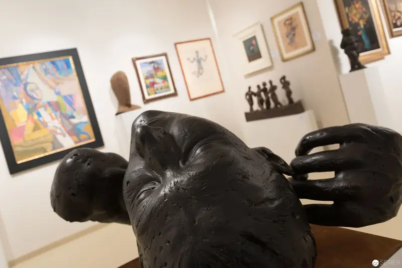 Dark Sculptural Form Amid Gallery Artworks at Vienna Art and Antique Fair