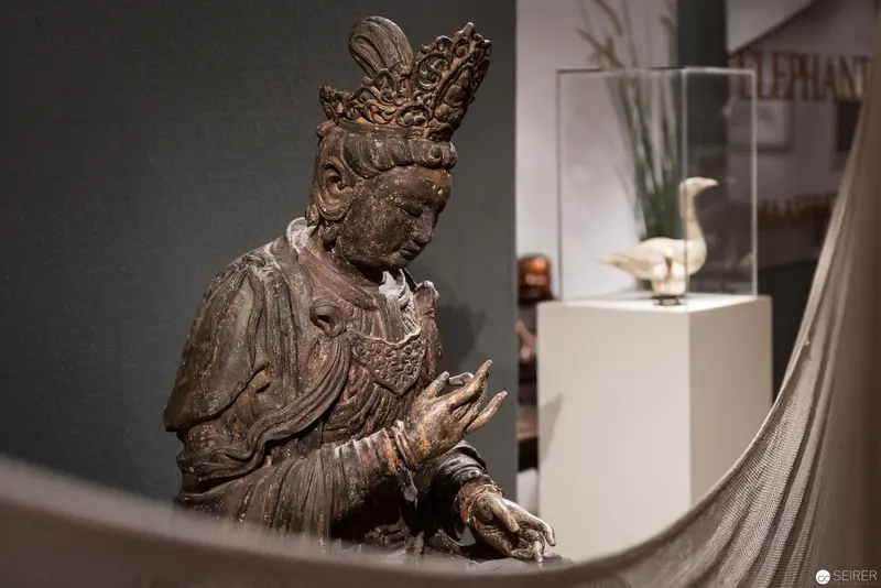 Bronze Bodhisattva Statue at Museum Exhibition with Decorative Bird Sculpture