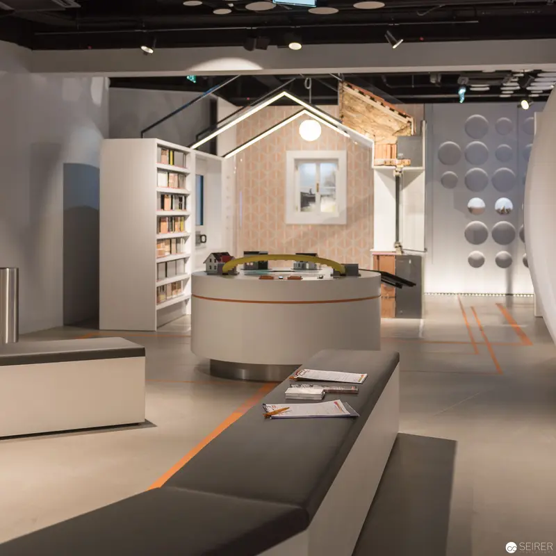 Architectural Exhibition Space with Miniature House and Design Elements