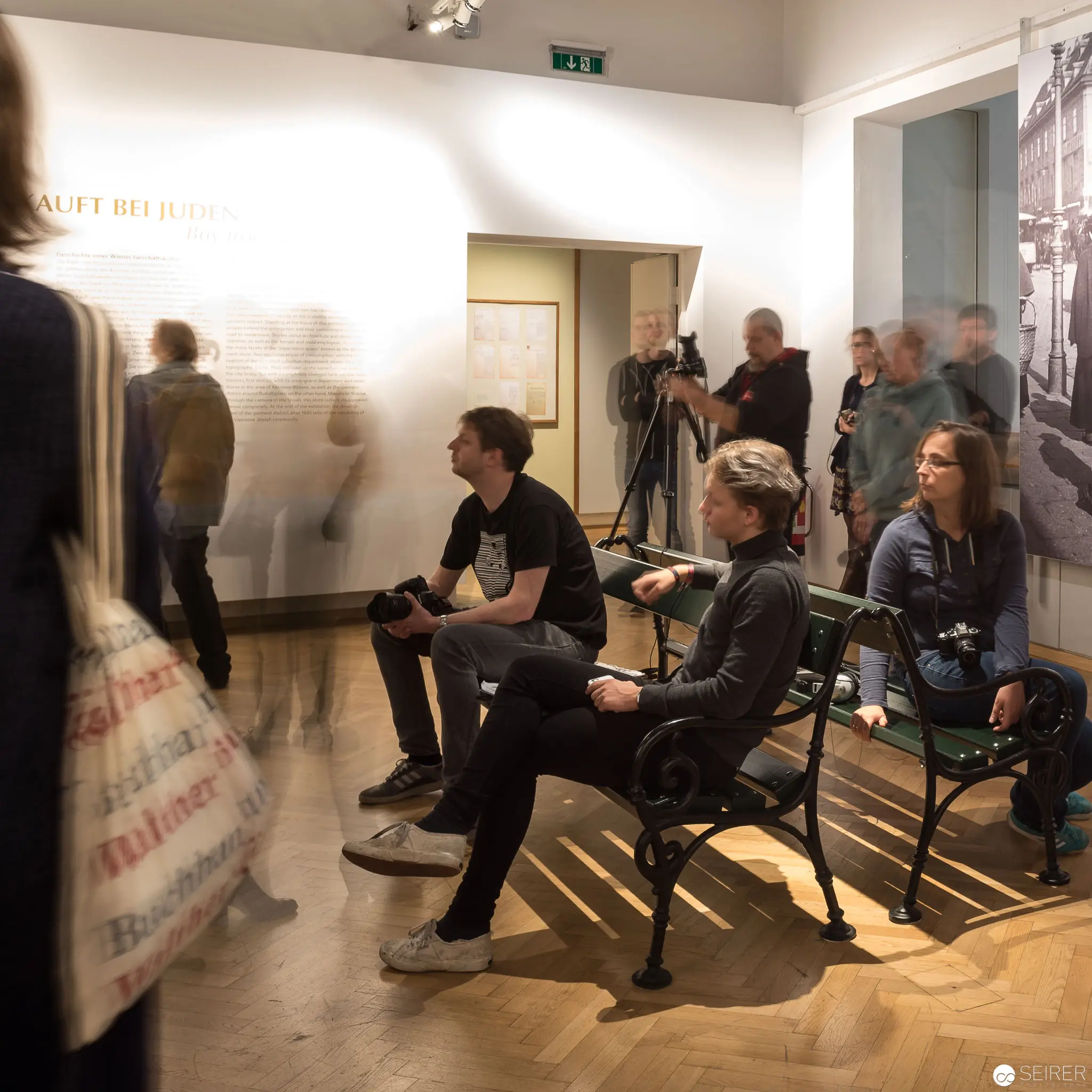 Museum Visitors Engaged in Contemplative Silence at Jüdisches Museum Wien