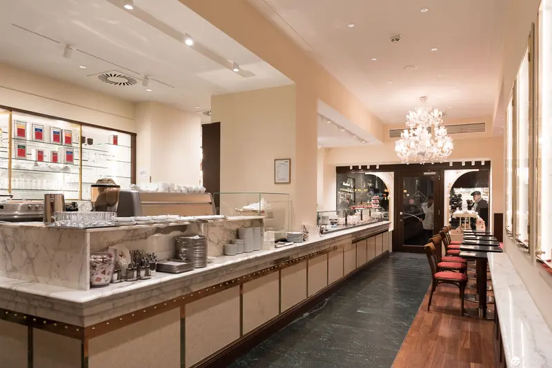 Elegantly Designed Café Interior with Marble Counter and Crystal Chandelier