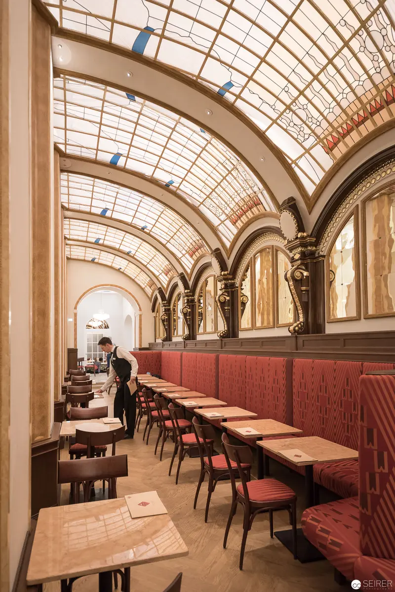 Ornate Café Interior with Vaulted Glass Ceiling and Art Nouveau Architectural Details
