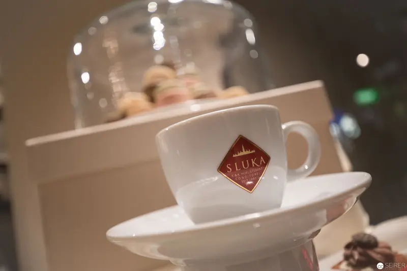 White Sluka Coffee Cup on Elegant Porcelain Saucer with Soft Bokeh Background