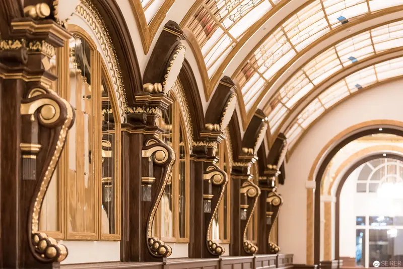 Ornate Architectural Interior with Arched Glass Ceiling and Decorative Columns