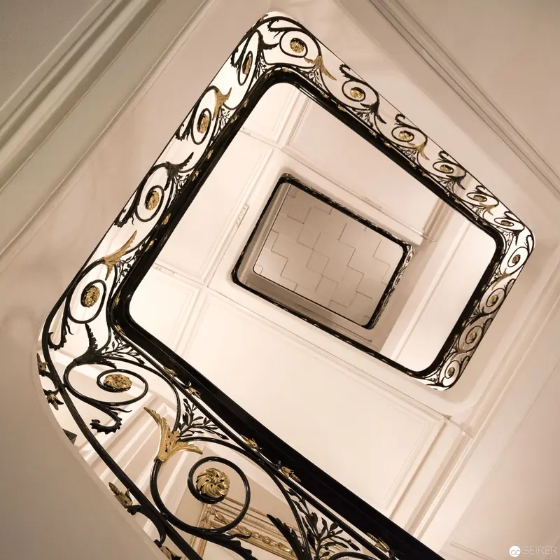 Elegant Spiral Staircase with Ornate Wrought Iron Railing at Vienna Venue