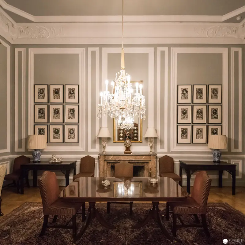 Elegant Formal Dining Room with Crystal Chandelier and Framed Portraits at British Embassy