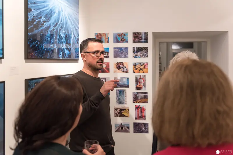 Wolf Hoffmann's Photographic Exhibition: Artist Discussing Work at Gallery Vernissage