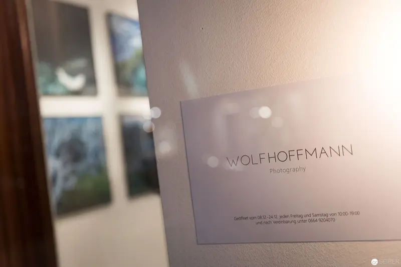 Wolfhoffmann Photography Studio Sign with Blurred Artworks in Background