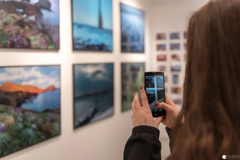Wolf Hoffmann Exhibition: Visitor Capturing Landscape Photography at Gallery Vernissage